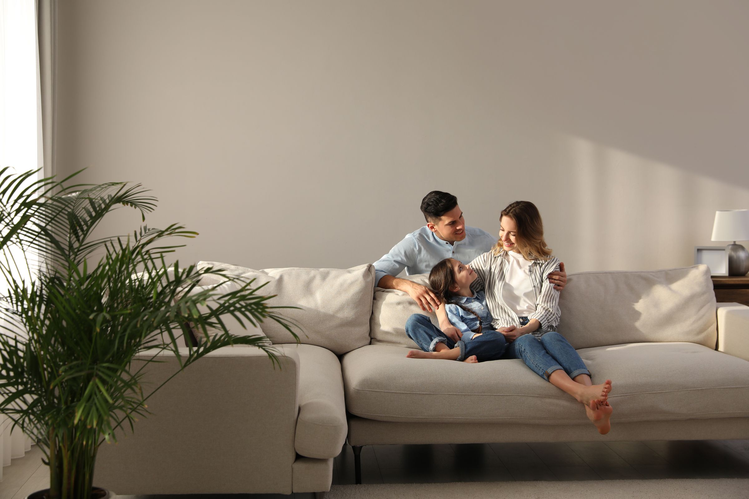 Family relaxing in the living room of their home